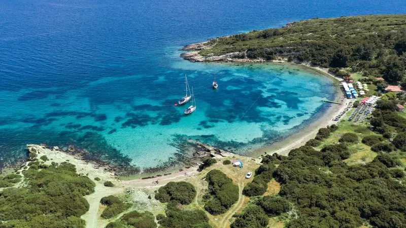 A turquoise bay on the Çeşme peninsula seen from above, boats at anchor